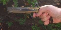 Holding the Cogswell belt pistol, showing its relative size